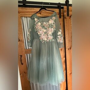 Floral embroidered party dress in sage green and peach.